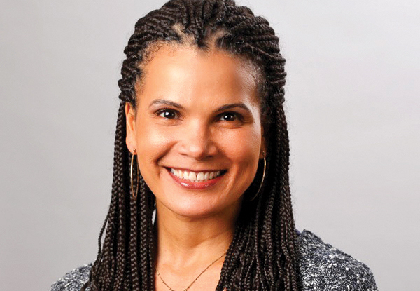 Woman with braided hair smiling at the camera.