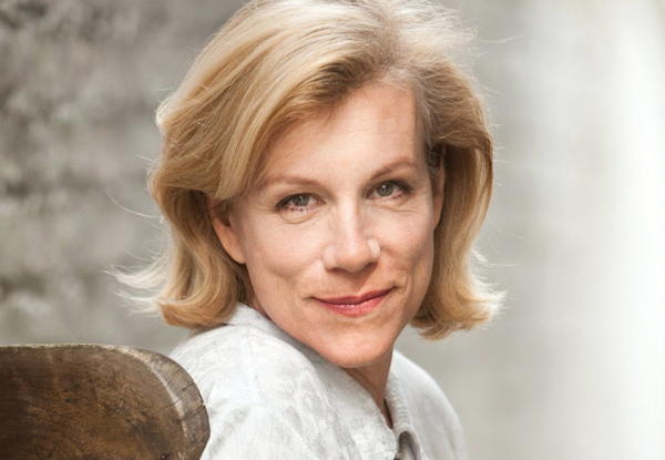 Portrait of a smiling middle-aged white woman with short blonde hair.