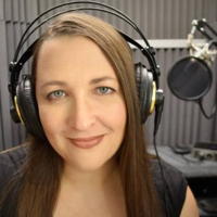 Woman with headphones in a recording studio.