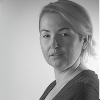 Black and white portrait of a woman with a slight smile, looking at the camera.